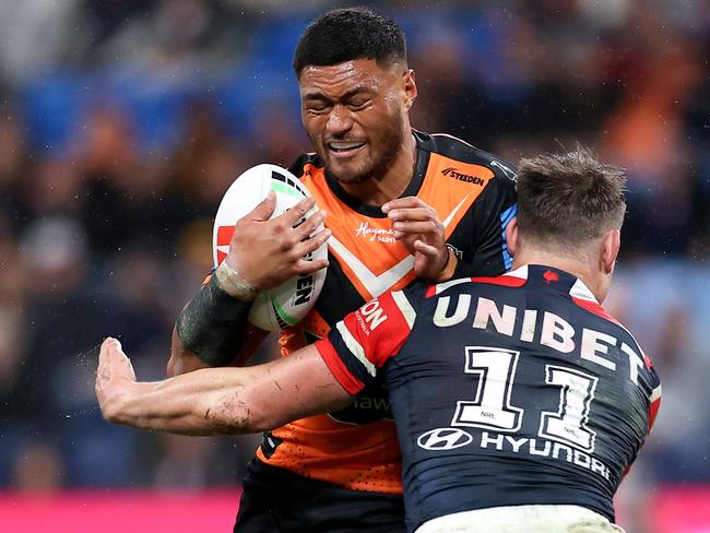 SYDNEY, AUSTRALIA - JUNE 30: Stefano Utoikamanu of the Tigers is tackled by the Roosters defence during the round 17 NRL match between Sydney Roosters and Wests Tigers at Allianz Stadium, on June 30, 2024, in Sydney, Australia. (Photo by Brendon Thorne/Getty Images)