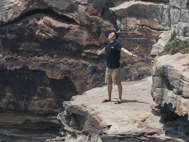 ***HOLD EMABARGO - CHECK WITH DT PIC DESK BEFORE USE***  Tourist climb over safety fences in order to get a dangerous selfie on top of Diamond Headland in Vaucluse. Photo: Tim Pascoe