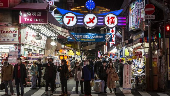 People wait to cross a road in Tokyo, Japan. Picture: Getty Images