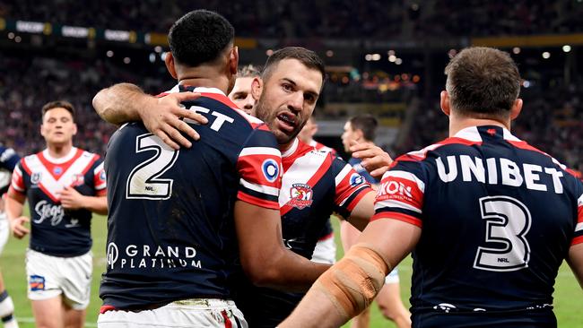 BRISBANE, AUSTRALIA - MAY 15: Daniel Tupou of the Roosters is congratulated by teammates after scoring a try during the round 10 NRL match between the Sydney Roosters and the North Queensland Cowboys at Suncorp Stadium, on May 15, 2021, in Brisbane, Australia. (Photo by Bradley Kanaris/Getty Images)