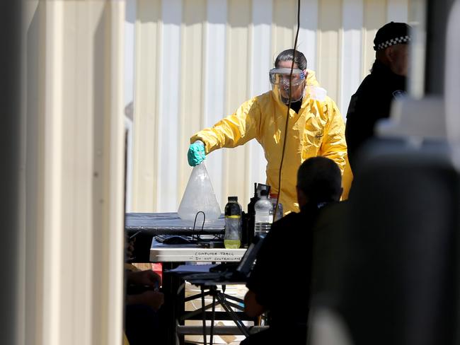 Forensic police at the home during the raid. Picture: AAP / Kelly Barnes