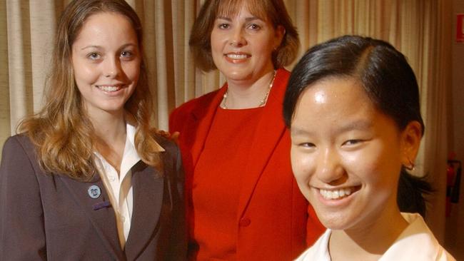 Marita Cheng (right) and Anna Rosendahl win the Mayoress of Cairns Youth Scholarship Award from Amanda Byrne in 2005.