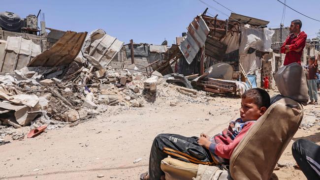 Palestinians inspect their house, after it was destroyed by an Israeli airstrike on Sunday. Picture: AFP