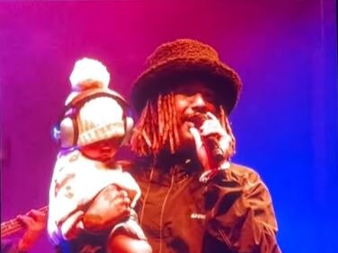 Ocean Alley’s frontman Baden Donegal performs with seven month old daughter Foxy at Splendour in the Grass 2023. Photo: Instagram @triple_j