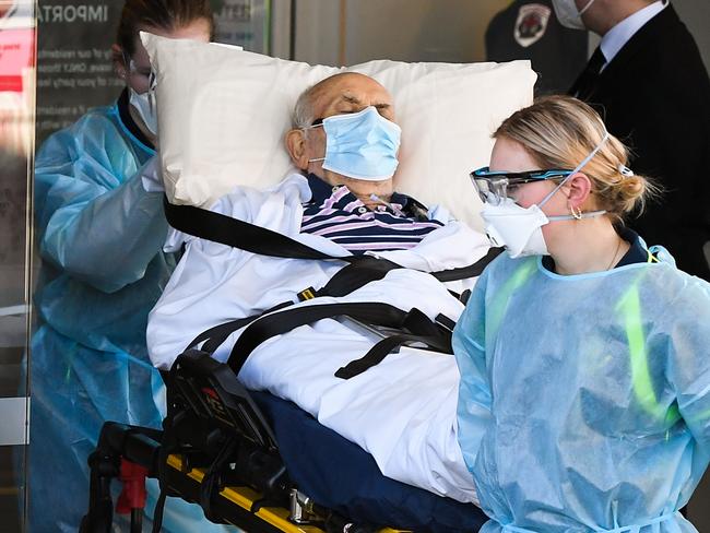 Ambulance officers transport a resident from the Epping Gardens aged care facility in the Melbourne suburb of Epping on July 29, 2020, as the city battles fresh outbreaks of the COVID-19 coronavirus. (Photo by William WEST / AFP)