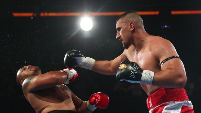 Justis Huni (right) clobbered Faiga Opelu to win the Australian heavyweight belt in his professional debut last October.