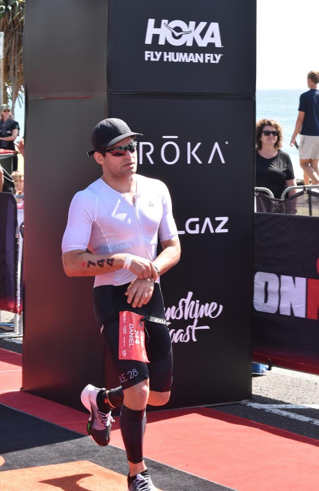 Athletes crossing the finish line at the Sunshine Coast Ironman 70.3 2023.