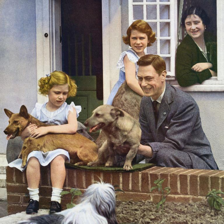 1933: George VI with his daughters Elizabeth (standing) and Princess Margaret along with the Queen Mother (then known as Queen Elizabeth) and their pet dogs outside Y Bwthyn Bach (The Little House) the gift of the Welsh people to Princess Elizabeth. Picture: Universal History Archive/Getty Images