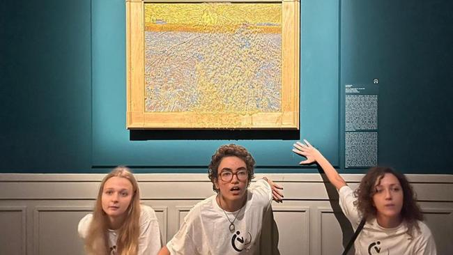 Climate activists from Last Generation posing by Vincent van Gogh’s The Sower after they threw pea soup at it at Rome's Palazzo Bonaparte. Picture: AFP