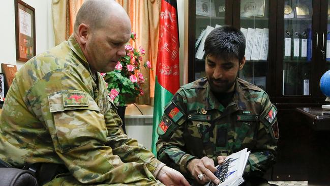 Australian Army Warrant Office Class One Brian Buskell and Afghan Army Sergeant Major Hamdard meet at the Afghan National Army Sergeant Major Academy.