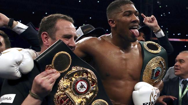 British boxer Anthony Joshua, centre, celebrates winning against Ukrainian boxer Wladimir Klitschko following their fight for Joshua's IBF and the vacant WBA Super World and IBO heavyweight titles, at Wembley Stadium. (Nick Potts/PA via AP)