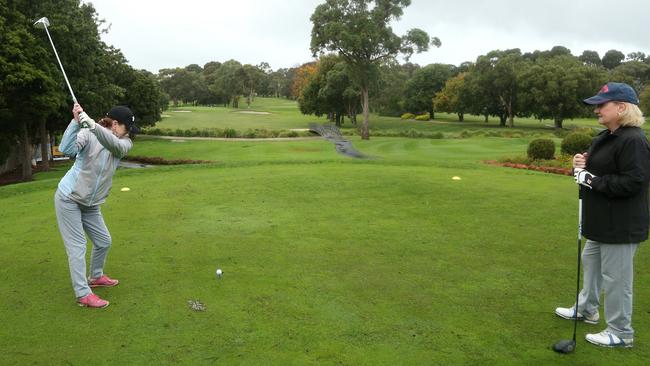 Bernie Tinsley and Lauris Weegberg enjoyed finally being able to hit the fairways at Box Hill Golf Course after coronavirus restrictions were eased. Picture: Hamish Blair