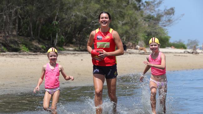 Gold Coast SUNS AFLW Lauren Ahrens with nippers on the beach at Currumbin. Left to right they are, Billie Berg7, Lauren Ahrens, Mila-May Berg 9. Picture Glenn Hampson