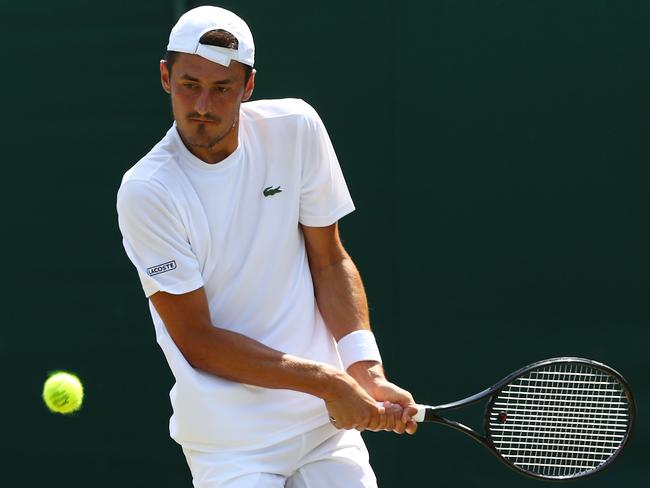 LONDON, ENGLAND - JULY 03:  Bernard Tomic of Australia returns against Hubert Hurkac of Poland during their Men's Singles first round match on day two of the Wimbledon Lawn Tennis Championships at All England Lawn Tennis and Croquet Club on July 3, 2018 in London, England.  (Photo by Matthew Stockman/Getty Images)