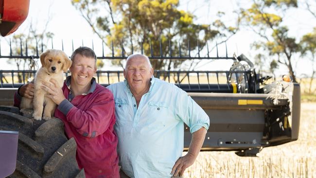 David and John Ferrier with Lotty the Golden Retriever puppy. Picture: Zoe Phillips