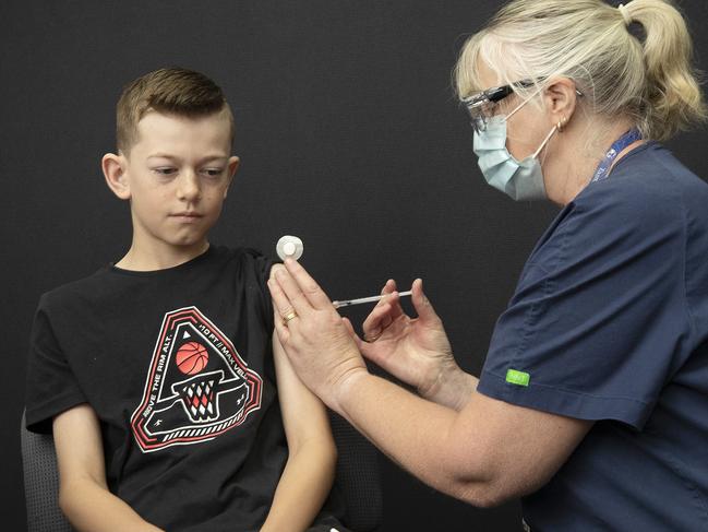 Lucas Watson 11 receives his Covid 19 vaccination from Nurse Immuniser Jen Graves at Brighton. Picture: Chris Kidd