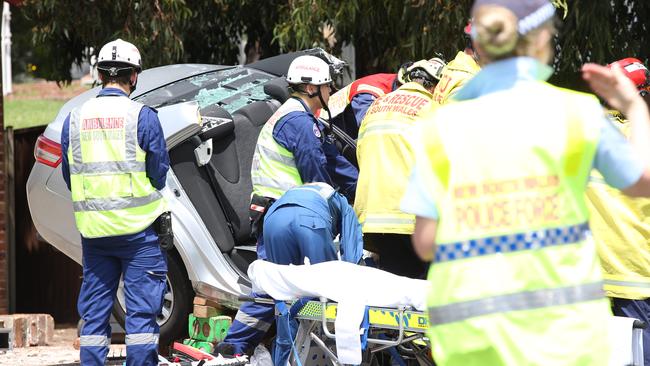 Emergency crews work with the jaws of life to cut free the driver from the wreckage. Picture: Melvyn Knipe
