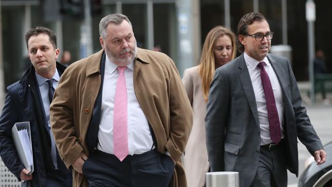 Legal representatives for Israel Folau, Stuart Wood (centre) and George Faros arrive at the Federal court in Melbourne, Tuesday, August 13, 2019. The Federal court is hearing a directions hearing for ex-rugby player Israel Folau who is taking Rugby Australia to court for unfair dismissal.(AAP Image/David Crosling) NO ARCHIVING