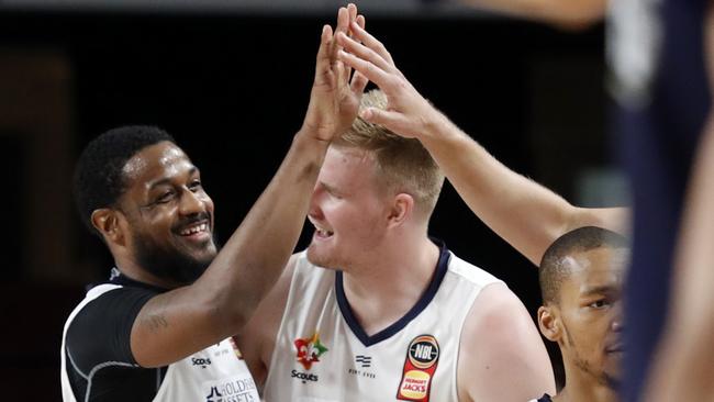 Ramone Moore celebrates his late steal and bucket that secured Adelaide 36ers’ victory over Perth Wildcats on New Year’s Day. Picture: AAP Image/Kelly Barnes