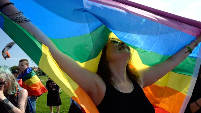 A woman holds the gay rights' movement rainbow flag during the gay pride rally in Saint Petersburg, Russia in 2017.