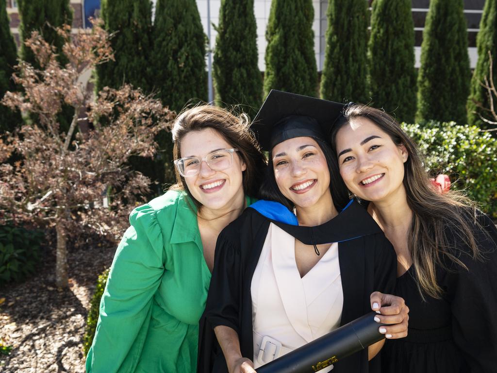 Master of Science graduate Aline dos Passos Silva with friends Luiza Sartori (left) and Marcela Reis at her UniSQ graduation ceremony at Empire Theatres, Wednesday, June 28, 2023. Picture: Kevin Farmer