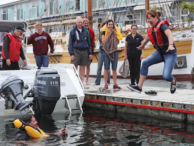 Julie Gathercole jumps into the water during a demonstration from Marine And Safety Tasmania about dodgy life jackets. Picture: LUKE BOWDEN