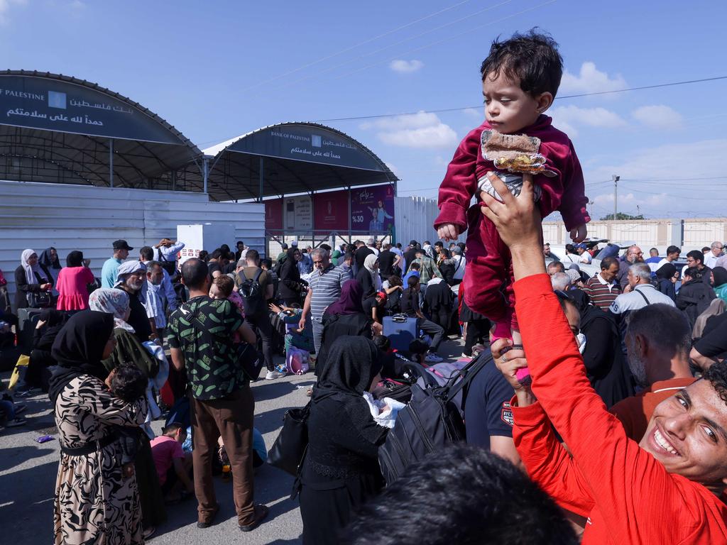 Palestinians, some with foreign passports hoping to cross into Egypt and others waiting for aid wait at the Rafah crossing in the southern Gaza Strip. Picture: AFP