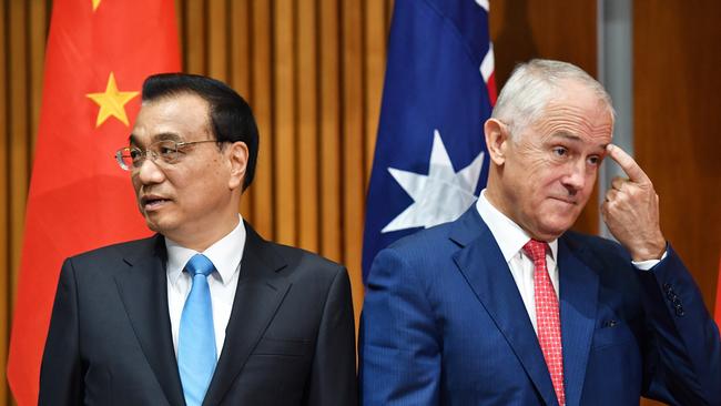 Alternative perspectives: Chinese Premier Li Keqiang and Malcolm Turnbull take a different view to the media at a signing ceremony in Canberra in March last year. Picture: AAP