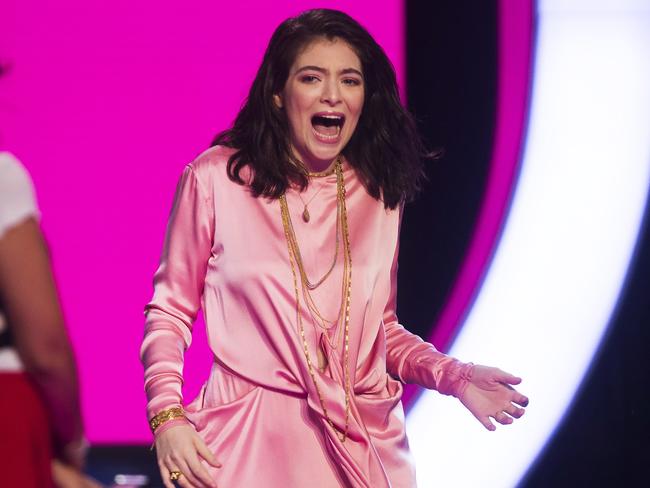 Lorde, right, reacts after being named iHeartRadio International Artist of the Year. Picture: Chris Young/The Canadian Press via AP