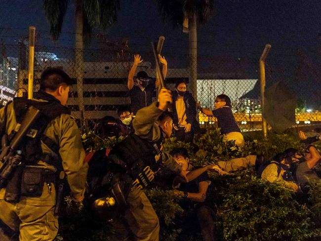 Police detain protesters and students after they tried to flee outside the Hong Kong Polytechnic University campus in the Hung Hom district. Picture: Getty Images