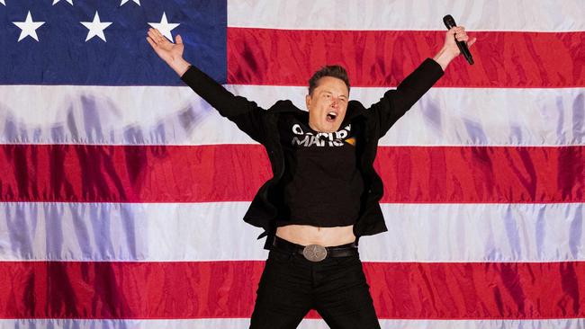 Elon Musk jumps on stage as he arrives to speak at a town hall event hosted by America PAC in support of former US President and Republican presidential candidate Donald Trump in Oaks, Pennsylvania, on October 18. Picture: Ryan Collerd/AFP