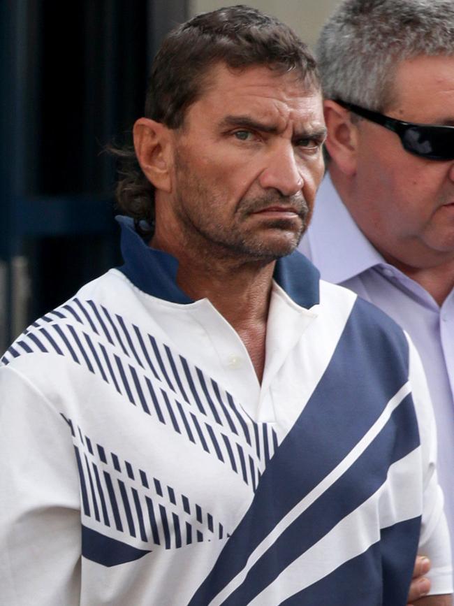 Carl Shane Bricola arrives in Cairns under police guard in November 2014 ahead of his appearance in the Cairns Magistrates Court after being charged with the stabbing death Robert Jamie Baartz south of Coen. Picture: Marc McCormack.