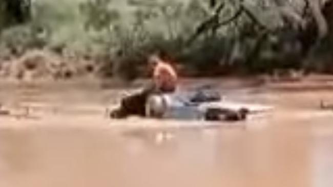 The man on the roof of his car in the Derwent Creek. Picture: Action for Alice