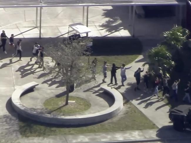 In this frame grab from video provided by WPLG-TV, students from the school evacuate the area Picture: WPLG-TV/AP