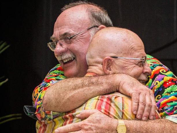 LNP MP Warren Entsch and COUCH co-founder Charles Woodward embrace at a function in March 2016, celebrating Entsch's 20-year anniversary of his election to federal parliament. Proceeds from ticket sales and raffle tickets went to COUCH. Picture: Facebook.