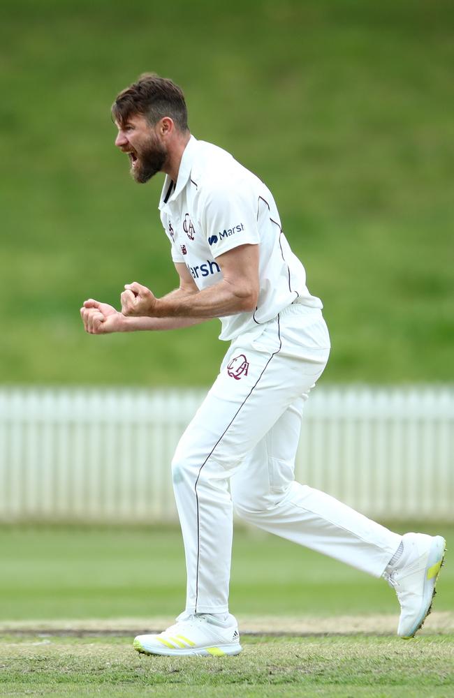 Michael Neser of the Bulls celebrates after taking the wicket of Daniel Hughes of the Blues during the Sheffield Shield match between New South Wales and Queensland at Drummoyne Oval on October 18, 2022 in Sydney, Australia. (Photo by Jason McCawley/Getty Images)