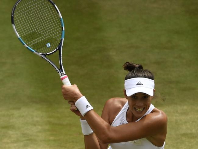 Spain's Garbine Muguruza returns to Slovakia's Magdalena Rybarikova during their Women's Singles semifinal match on day nine at the Wimbledon Tennis Championships in London Thursday, July 13, 2017. (Tony O'Brien/Pool Photo via AP)