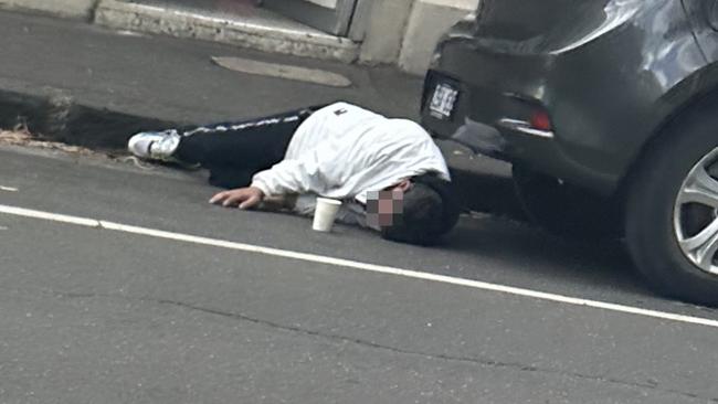 A man drifts in and out of consciousness on a Richmond street. Picture: news.com.au