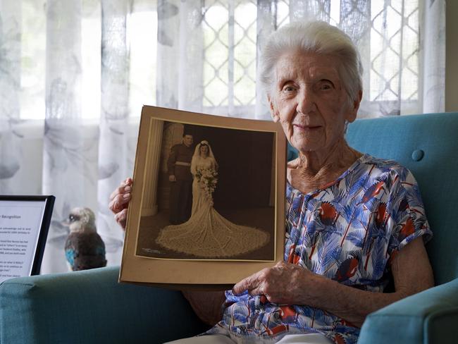 Mackay great-grandmother Norma Wood with a photograph from her wedding to Dudley. Inset is one of her kookaburras, Norma’s favourite birds. Picture: Heidi Petith