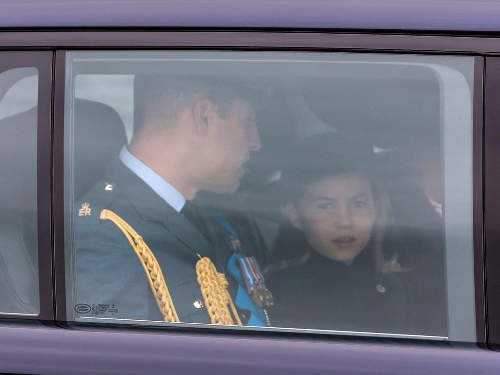 Britain's Prince William, Prince of Wales, and her daughter Britain's Princess Charlotte of Wales arrive at Westminster Abbey.