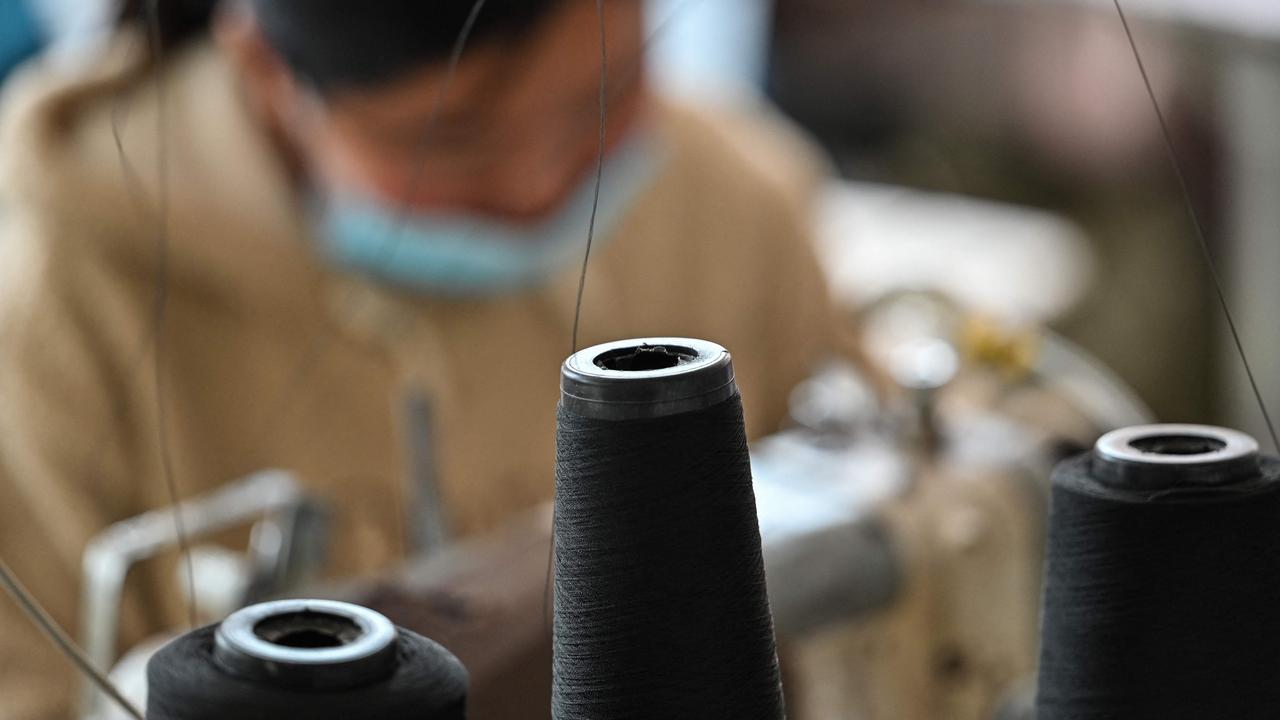 This photo taken on March 25, 2021 shows a worker sewing at a lingerie factory in Guanyun county, some 50 kilometres from Lianyungang in China's northeastern Jiangsu province. - Americans like their lingerie to be risque, Europeans prefer it more classy, and Chinese remain a bit shy but are opening up. But the biggest order of all came from North Korea. (Photo by Hector RETAMAL / AFP) / To go with AFP story China-clothing-lingerie, FOCUS by Dan Martin