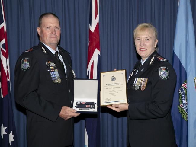 Queensland Police Service Central Region Assistant Commissioner Kevin Guteridge is presented with his appointment certificates and epaulettes at a recent ceremony by Commissioner Katarina Carroll.