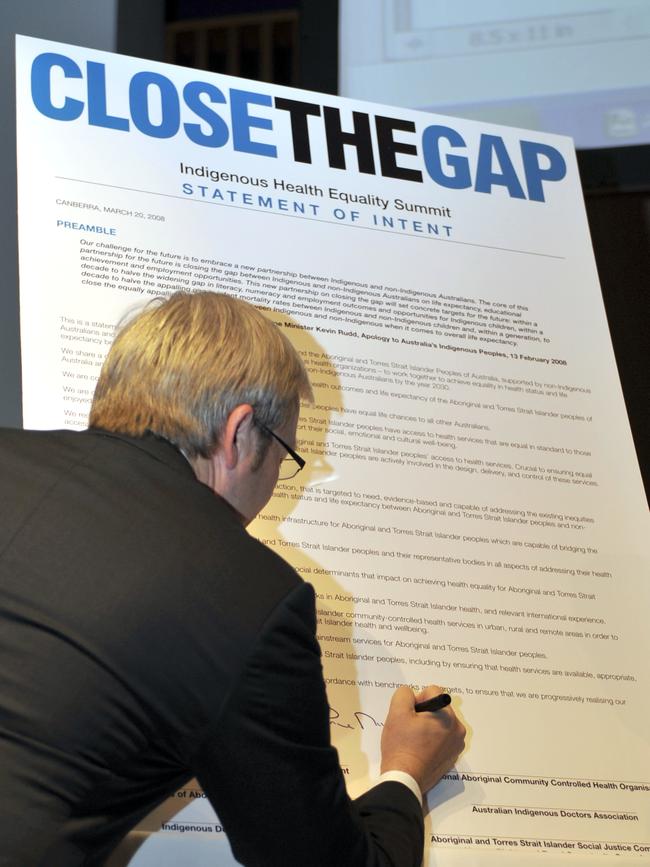 Then prime minister Kevin Rudd signs the “Closing the Gap” statement of intent at the Indigenous Health Equality Summit in 2008. Picture: AAP Image/Alan Porritt