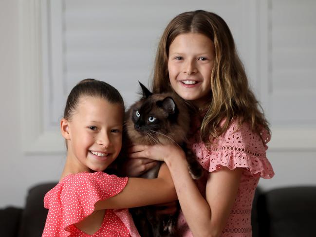 Alannah Sumner (9) and Lily Sumner (11) and Alannah (9) pictured with their cat Smokey at their Cherrybrook home. 19th February 2021. Picture by Damian Shaw