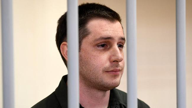 US ex-marine Trevor Reed stands inside a defendants' cage during a court hearing in Moscow in 2021. Picture: AFP.