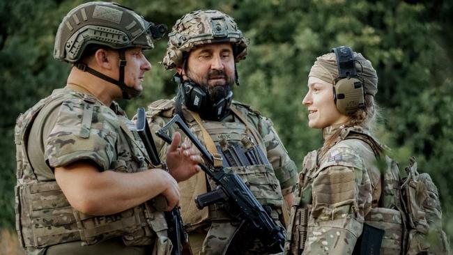 Yelyzaveta “Liza” Komar, right, on the Ukrainian frontline, where she serves as a combat medic aiding in evacuations. Picture: 3rd Assault Brigade battalion photographer