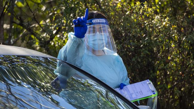 Nurses are seen doing COVID-19 testing at a drive-through fever clinic in Ipswich on August 24. Picture: Getty Images.