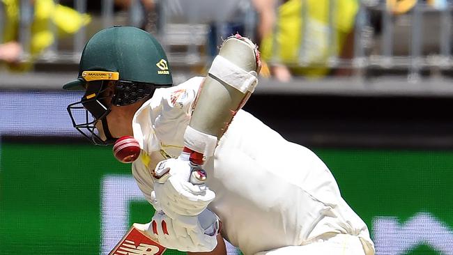 Australia’s Pat Cummins is hit by a bouncer — both tails were peppered with short stuff. Picture: AFP