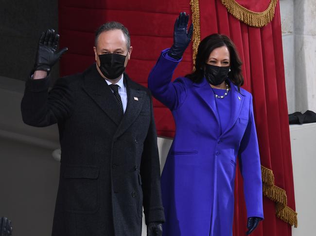 Kamala Harris and her husband Doug Emhoff wave as they arrive for the inauguration. Picture: AFP