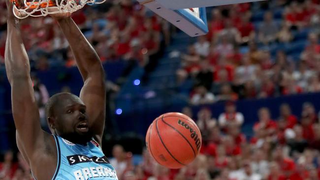 Majok Majok of the Breakers hangs from the basket after scoring during the Round 4 NBL match between the Perth Wildcats and the New Zealand Breakers at Perth Arena in Perth, Saturday, November 3, 2018. (AAP Image/Richard Wainwright) NO ARCHIVING, EDITORIAL USE ONLY